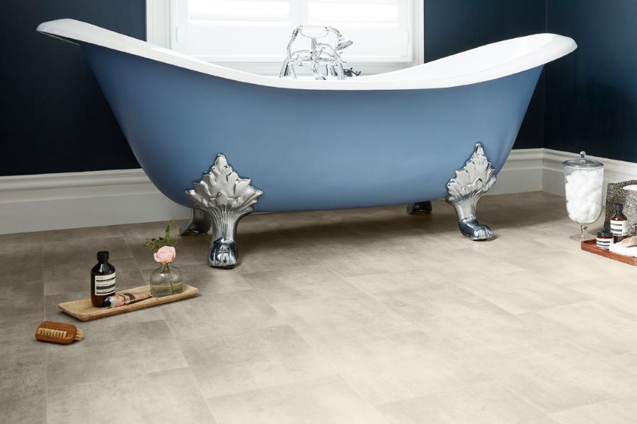 blue clawfoot bath with light grey stone tiled vinyl bathroom flooring